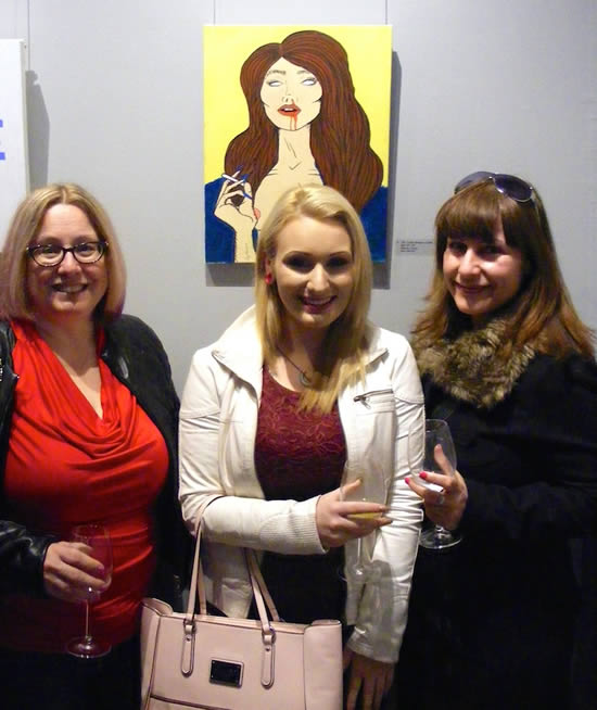 Rhiannon deWit and fans with her painting TROUBLE
